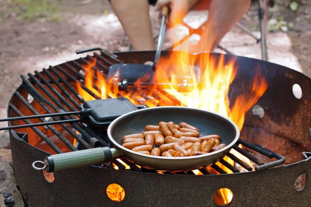 skillet and pie irons cooking over a fire