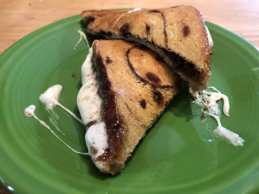 cinnamon bread stuffed with Nutella and marshmallows sandwich on green plate