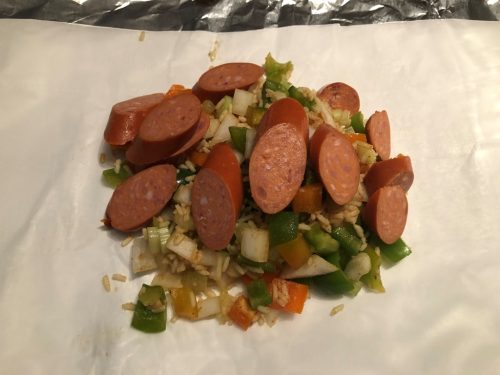 sausage placed on top of rice mixture