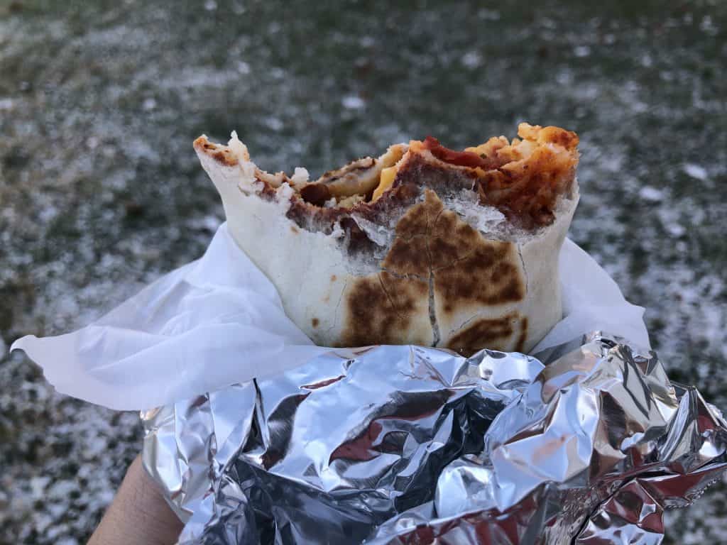 camping breakfast burrito being eaten