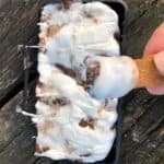 cast iron smores dip in a pie iron with a scooby snack stick for dipping