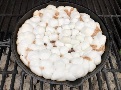 cooked marshmallows and chocolate in cast iron skillet smores dip