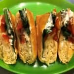 spinach & red bell pepper strips with cream cheese in crescent roll dough on green plate