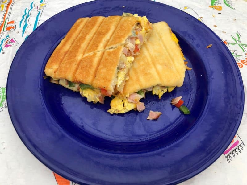 ham and cheese omelet cooked in crescent dough on blue plate
