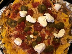 nachos baked in a dutch oven over the campfire