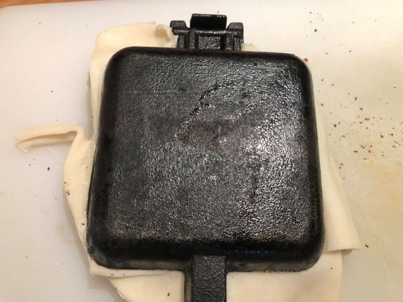 closed pie iron, crust sticking out