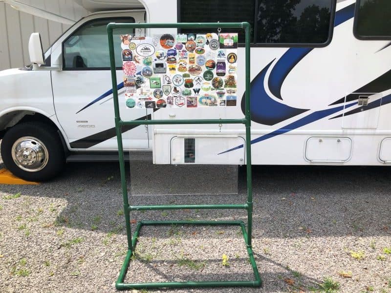 two tier display of stickers made from pvc pipe and plexiglass outside a Class C RV
