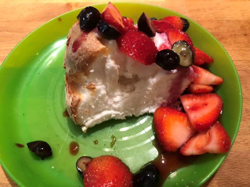 grilled fruit topping angel food cake on green plate