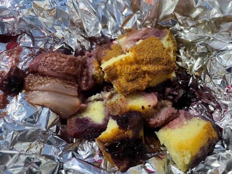 cubes of cake and fruit cooked in aluminum foil