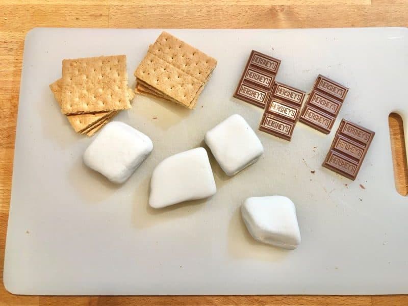 chocolate, marshmallows, and graham crackers on cutting board