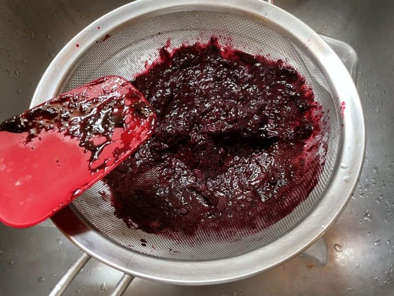blueberry mash in a sieve