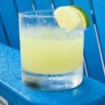 pineapple limeade in glass on blue chair